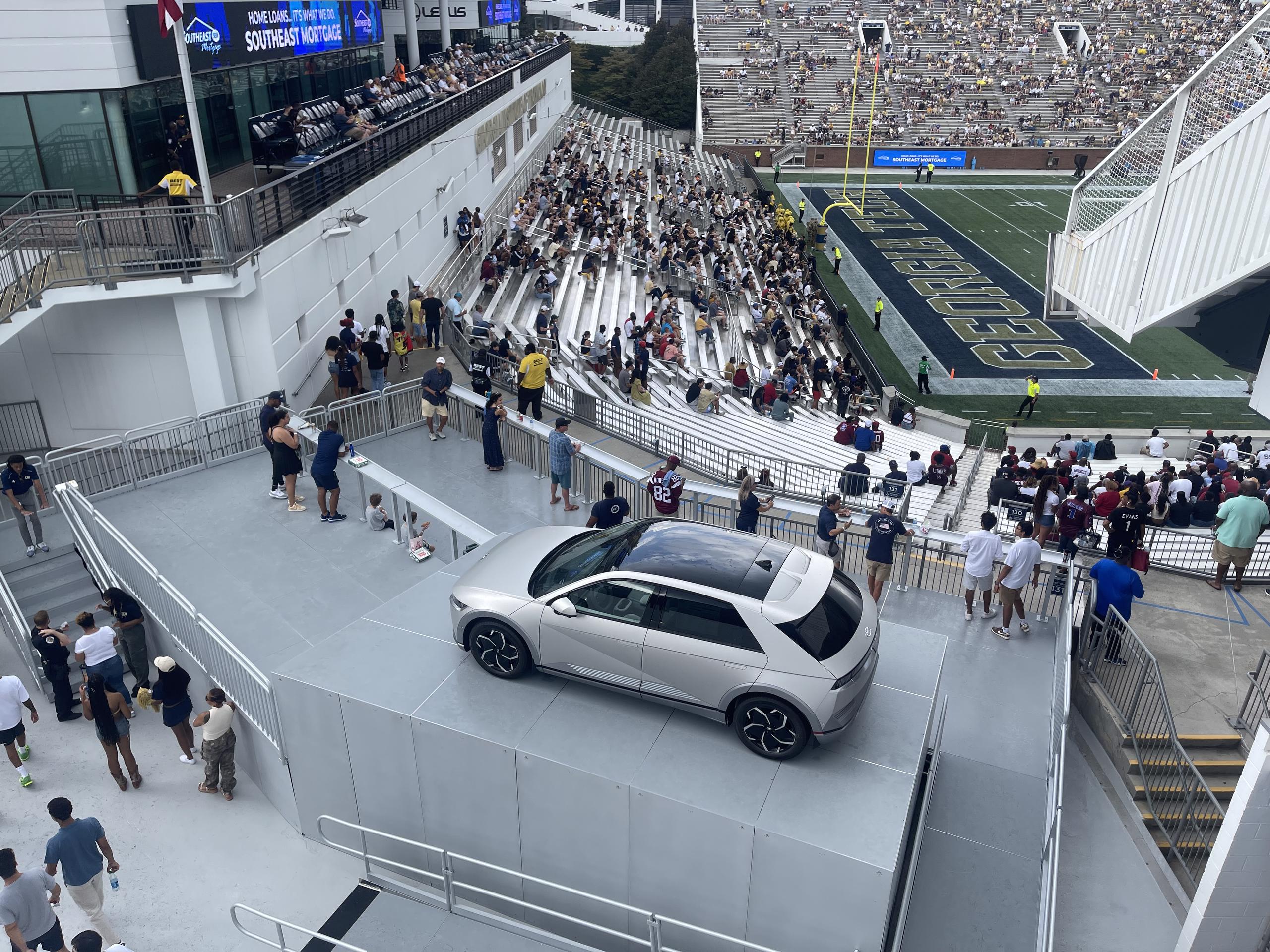 Bobby Dodd Stadium at Hyundai Field stage with railing that are supporting a car